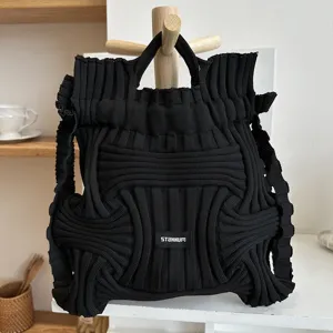 Niche black knitted woven backpack with unique geometric pattern and STANNUM logo