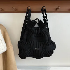 Chic black knitted dual-use backpack and handbag with unique woven texture design.