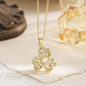 Macro detail view of an elegant gold floral pendant necklace with pearl and stones
