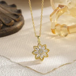 Close-up of rotatable gold flower pendant necklace with shimmering crystals