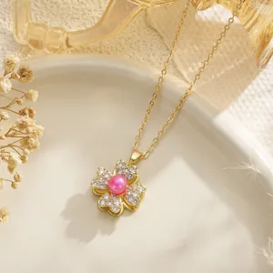Detailed macro shot of a golden double-layer rotating four-leaf clover flower pendant