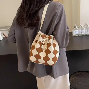 Stylish wavy diamond pattern knit bucket bag with drawstring closure for modern women