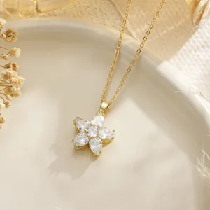 Detailed macro view of a gold flower necklace pendant with marquise-cut stones