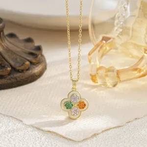 Detail view of a rotatable vintage-style four-leaf clover pendant with colorful stones.