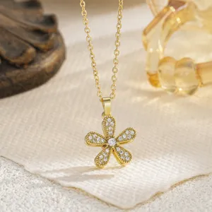 Macro view of a delicate golden rotatable daisy flower fidget pendant set with clear crystals.