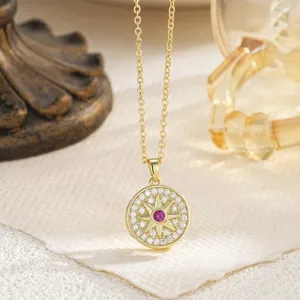 Close-up of gold-plated octagram pendant with pink stone and white cubic zirconia