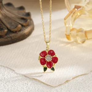 Close-up of a red enamel camellia flower pendant necklace with sparkling center zircon detail.