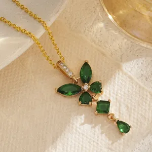 Close-up view of gold-plated necklace with green zirconia stones in butterfly pendant