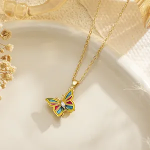 Detailed macro view of a colorful enamel butterfly pendant featuring a central zircon