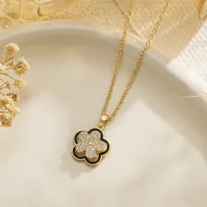 Detailed macro view of a golden flower fidget pendant with sparkling crystals and black enamel edge.