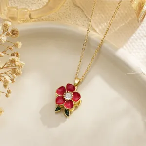 Detailed view of a rotatable red enamel flower necklace with a sparkling cubic zirconia center