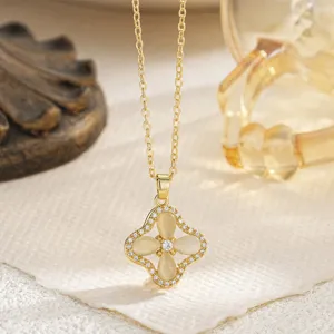 Detailed view of an elegant vintage-style four-leaf clover pendant necklace with opal petals
