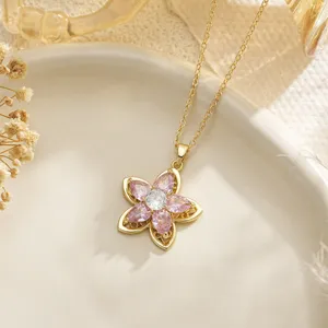 Macro detail view of an elegant flower pendant with pink marquise gems on gold chain