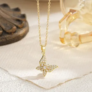 Close-up of gold butterfly pendant necklace with sparkling cubic zirconia stones.