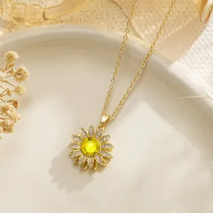 Close-up of rotatable sunflower fidget necklace with yellow crystal and gold-plated finish