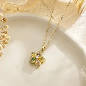 Detailed close-up of a gold flower necklace pendant with multi-colored gemstones