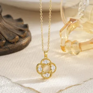Detailed view of an elegant vintage gold necklace with a rotatable clover flower pendant