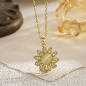 Close-up of golden sunflower fidget pendant with sparkling crystals and cat's eye stone