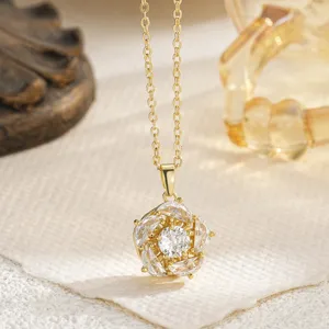 Detail shot of a gold-plated flower pendant necklace with shimmering white gemstones.