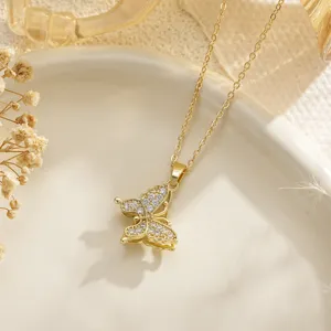 Detailed macro view of a golden butterfly necklace pendant set with clear cubic zirconia