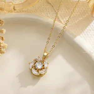 Detailed close-up of a gold flower pendant necklace with shimmering clear crystals
