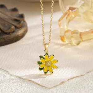 Close-up of a vibrant yellow and green daisy flower pendant on a dainty gold chain