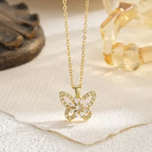 Close-up of gold butterfly pendant necklace with shimmering zircon stones for women