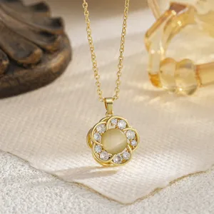 Detailed macro view of golden rotating flower pendant necklace with sparkling zirconia stones