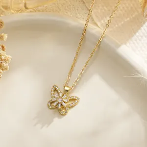 Detailed view of a gold butterfly pendant necklace with sparkling zircon crystals.