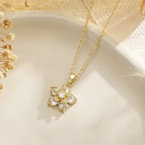 Close-up of elegant gold flower pendant necklace with sparkling white cubic zirconia