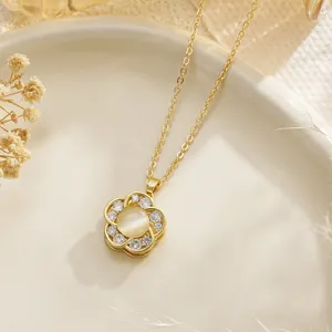 Detail view of gold rotating daisy fidget necklace with cat's eye stone