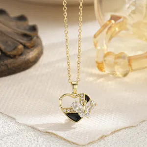 Detailed close-up of a gold-plated heart pendant featuring a zircon butterfly and black enamel inlay