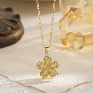 Close-up of elegant golden revolving flower pendant necklace with shiny opal stones