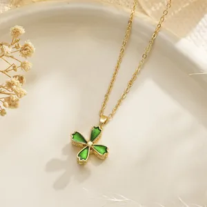 Close-up of golden rotating flower pendant necklace with green enamel and zircon