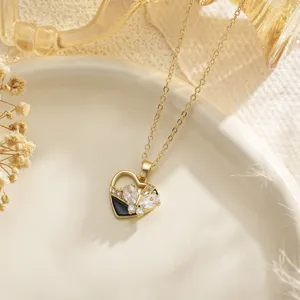 Detailed view of a golden heart pendant with a rotating zircon butterfly