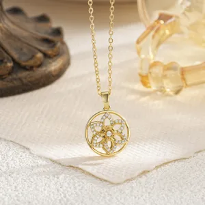 Close-up detail of a delicate gold-toned flower pendant necklace with crystal accents