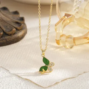 Exquisite macro detail of green enamel and sparkling zirconia butterfly pendant.