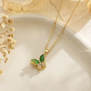 Detailed close-up of green enamel butterfly pendant necklace with zircon accents