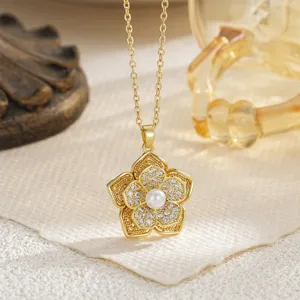 Detailed view of golden rotating flower pendant necklace with shimmering crystals and pearl