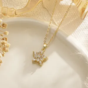 Close-up detail of a gold-plated flower pendant necklace with shimmering crystals