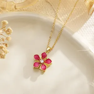 Close-up of a pink enamel flower necklace with a rotating zircon center pendant
