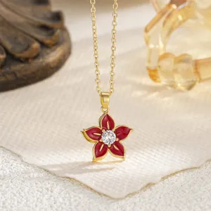 Detailed view of red enamel flower pendant with sparkling center zircon.