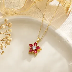 Close-up view of elegant rotatable red camellia flower pendant necklace with clear zirconia