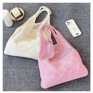 Vista detallada de bolsos tote de ganchillo rosa y blanco roto con diseño calado