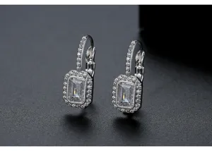 Elegant silver halo drop earrings featuring emerald-cut zircon stones and vintage lever-back.