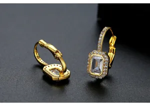 Close-up of vintage gold-plated hoop earrings featuring rectangular emerald-cut zircon