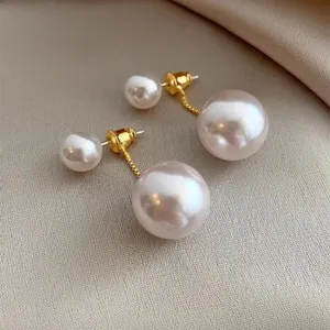 Detailed macro view of elegant dual-wear pearl drop earrings on a soft silk background