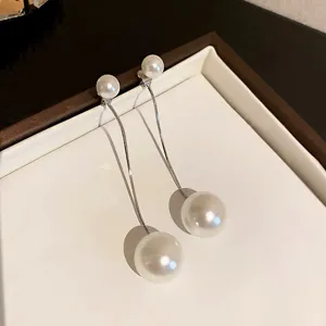 Detailed view of elegant two-way pearl tassel earrings with silver-toned snake chains and pearls