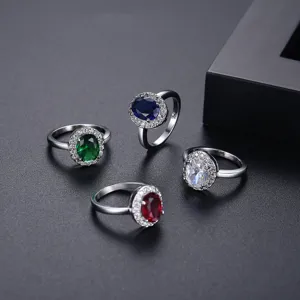 Elegantes anillos halo plateados con vibrantes gemas de circonita cúbica multicolor