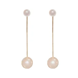 Elegant long drop earrings featuring two round pearls on a delicate gold-toned metal bar.